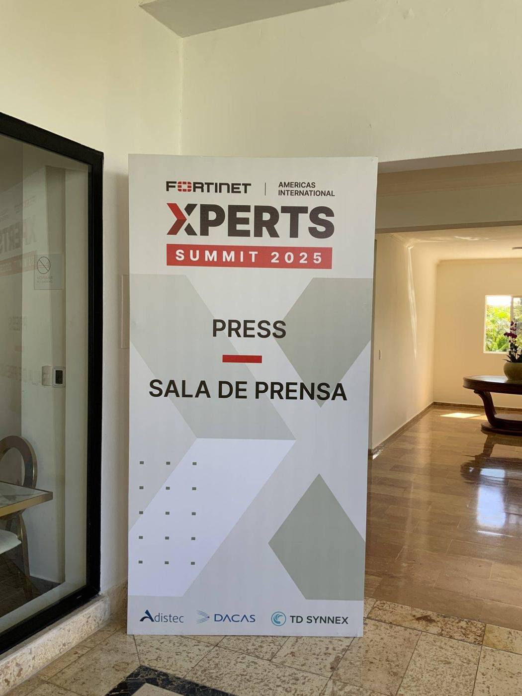 A banner for the Fortinet XPERTS Summit 2025 press room, Sala de Prensa, inside a Punta Cana resort