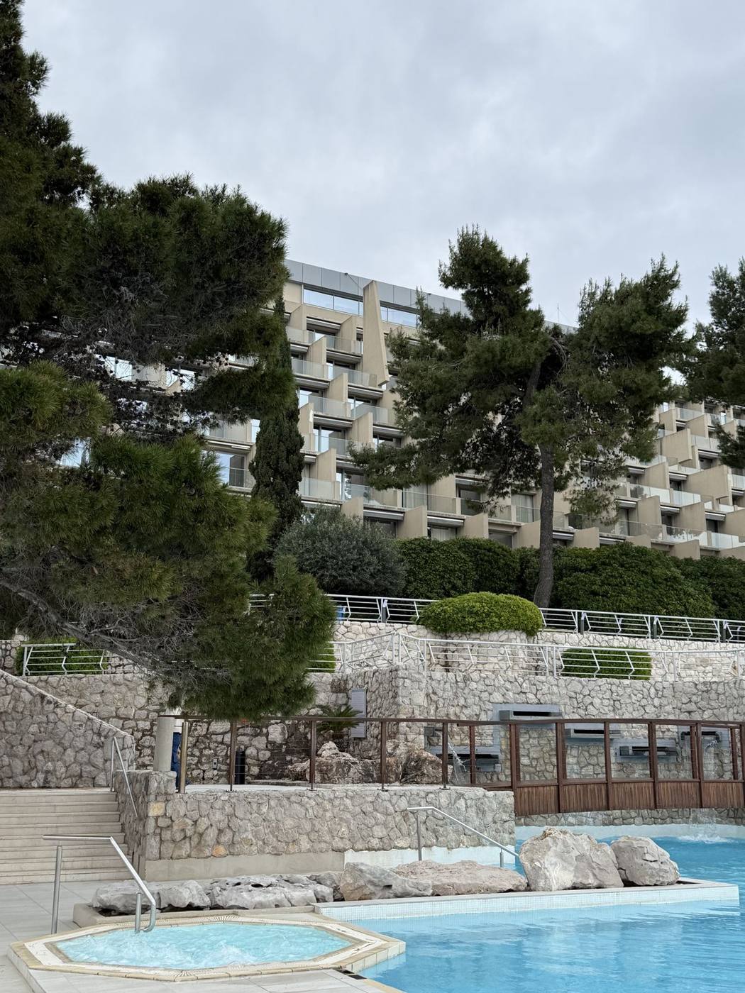 Pine trees and terraced pools in front of a hotel on the Lapad peninsula in Dubrovnik