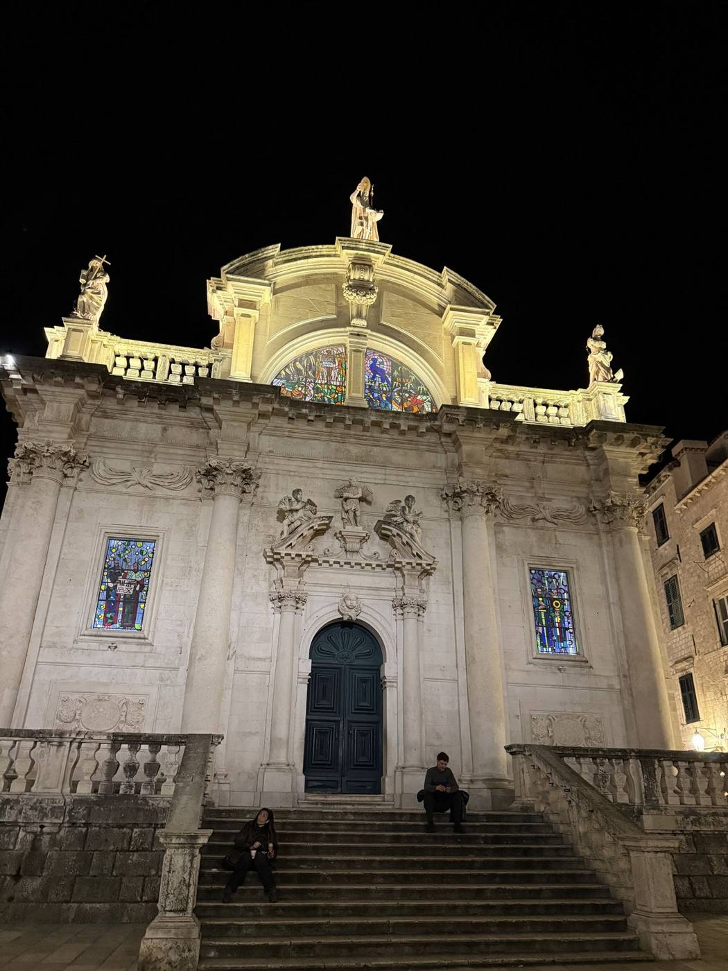 The ornate baroque Church of St. Blaise lit up against the night sky