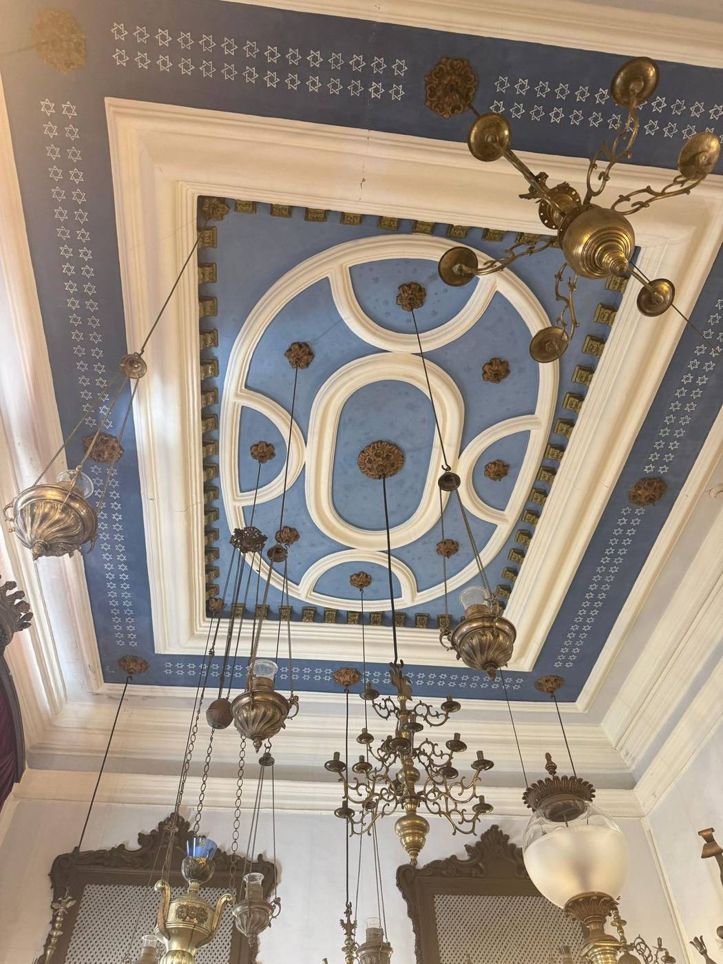 A sky-blue painted ceiling with brass hanging lamps inside the Dubrovnik Synagogue