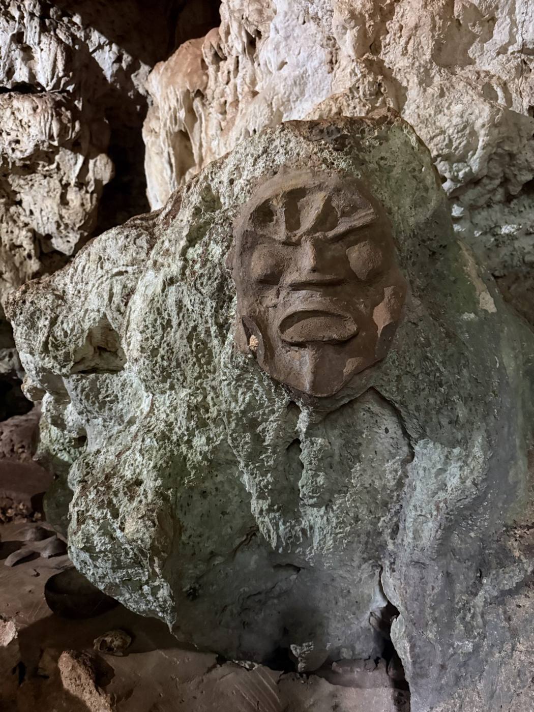 A carved Taíno face in the rock wall of a cave near Cabarete