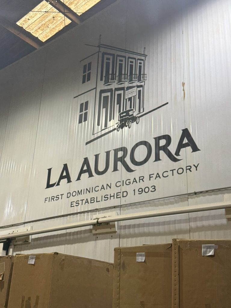 The La Aurora logo on a factory wall: First Dominican Cigar Factory, established 1903