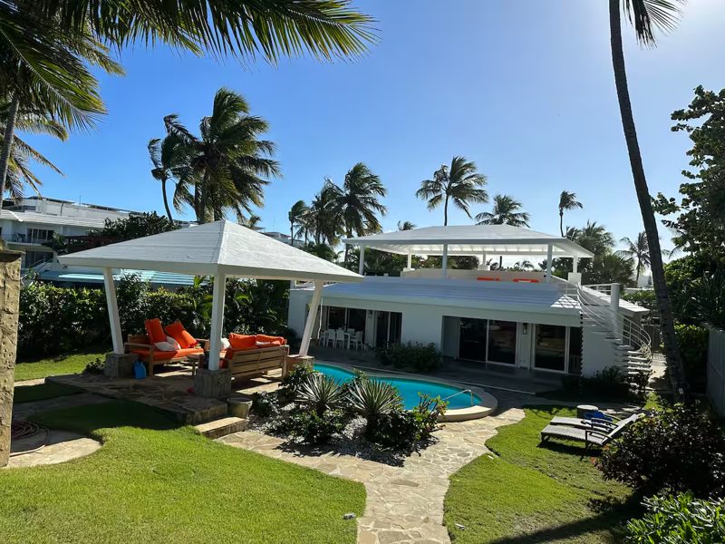 A private villa pool surrounded by palm trees in Cabarete, on the Dominican Republic’s North Coast