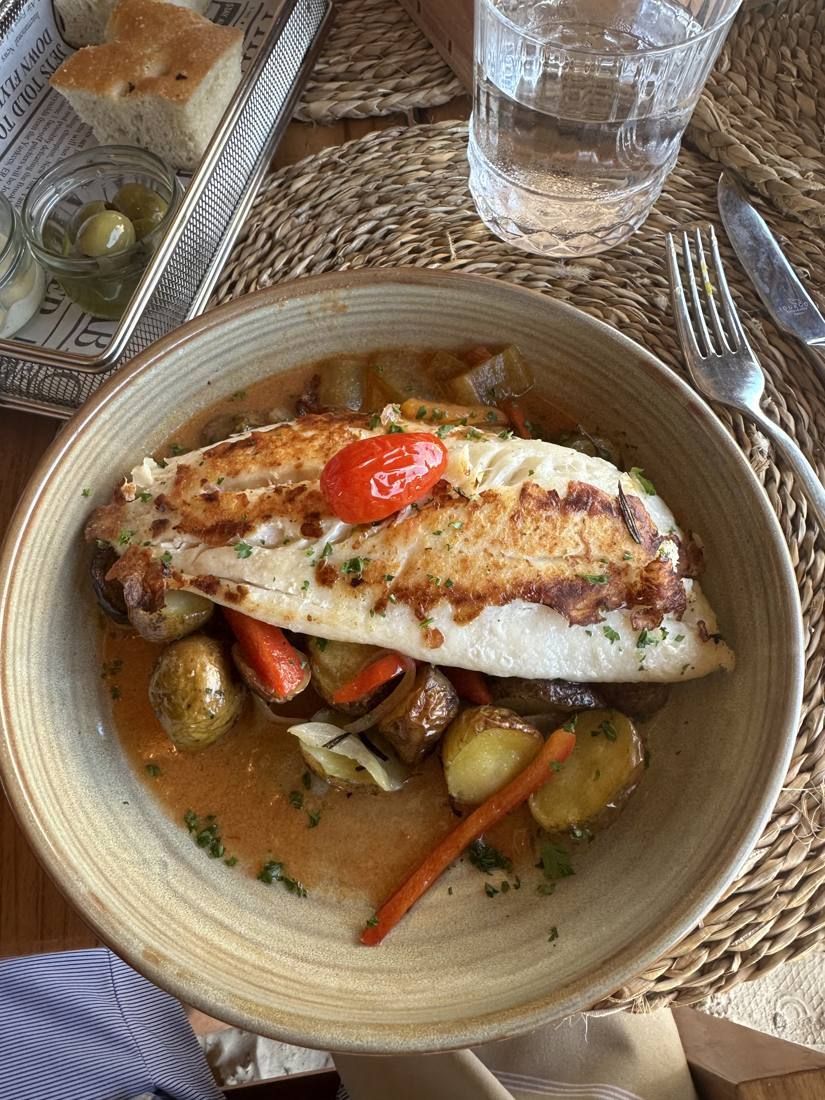 Plated fish dinner with vegetables
