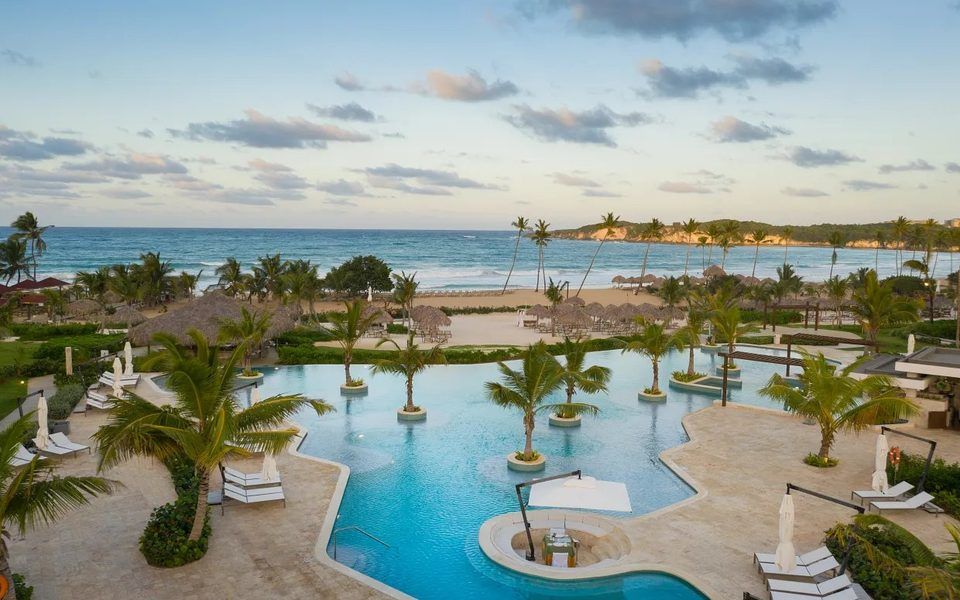 Pool with palm islands and the beach behind at Dreams Macao Beach