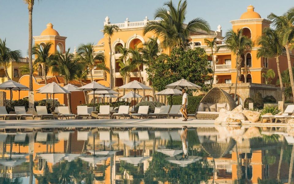 Sanctuary Cap Cana's castle-style buildings reflected in the pool