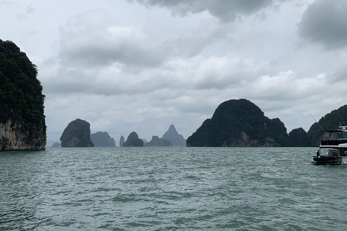 Limestone karst islands rising from the green water of Phang Nga Bay near Phuket