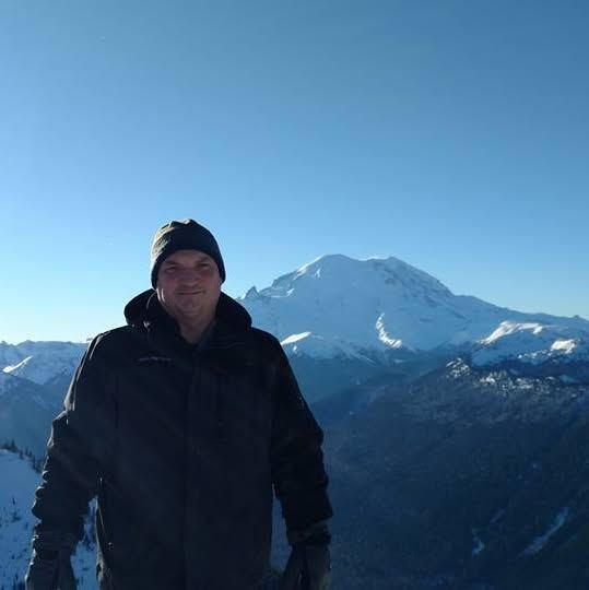 Hiking in the snow with Mount Rainier in the background